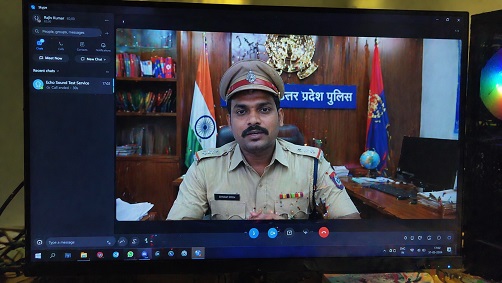 Fake police station setup visible on a video call